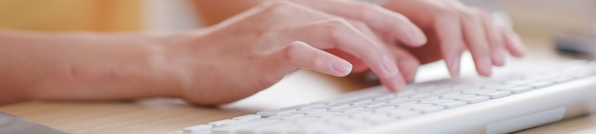 Female hands typing on a computer keyboard