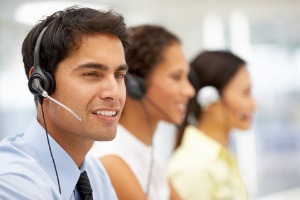 Customer services representative wearing a headset talking to customer on phone 