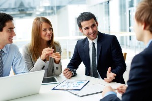 business team discussing documents and ideas at a sales meeting