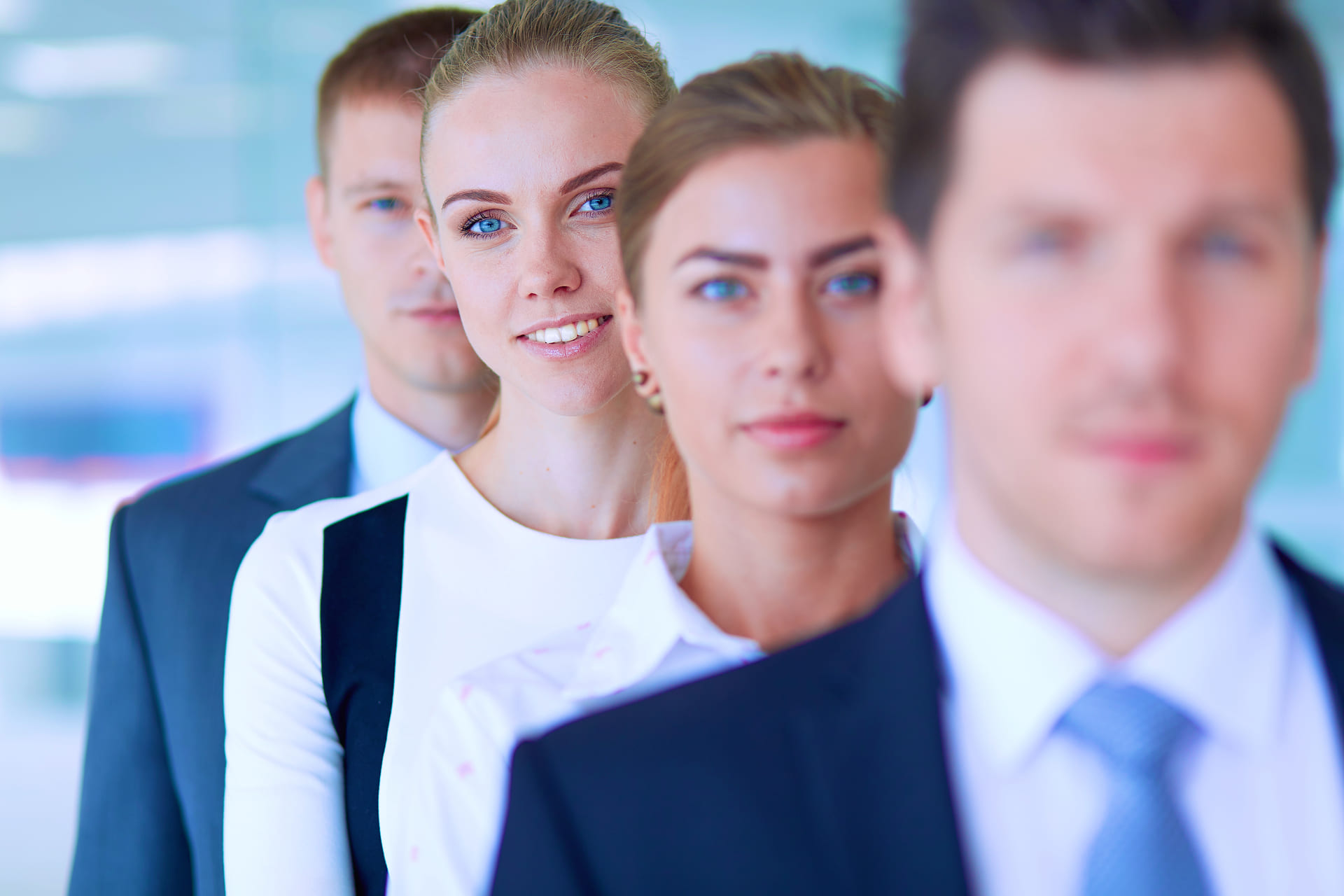 Smiling successful business team standing in office