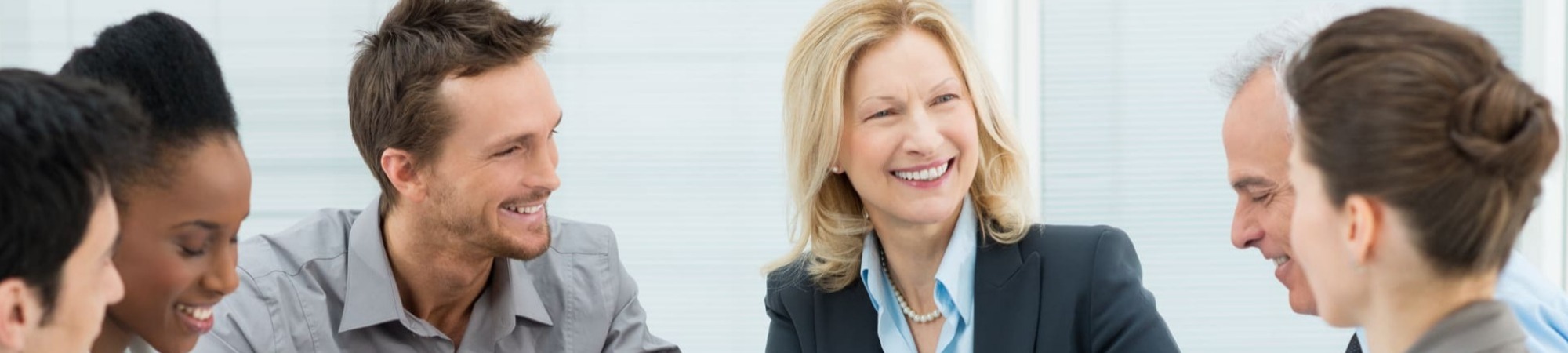 Group of happy co-workers having a discussion in a conference room